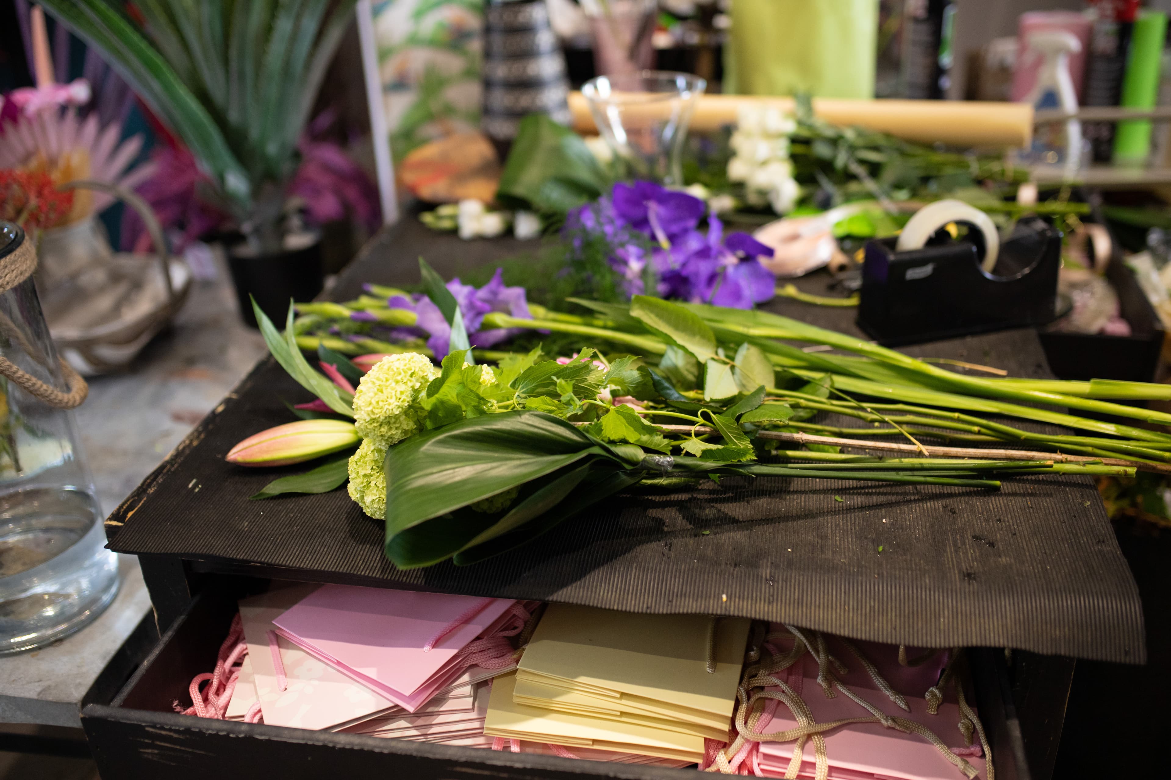Professional florist bench with flowers in preparation